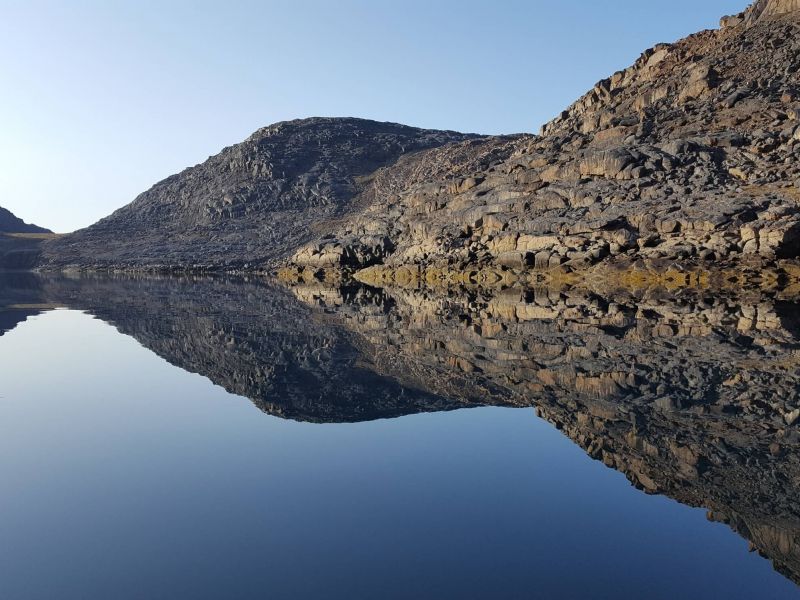 Scenic rocky hills reflected in water